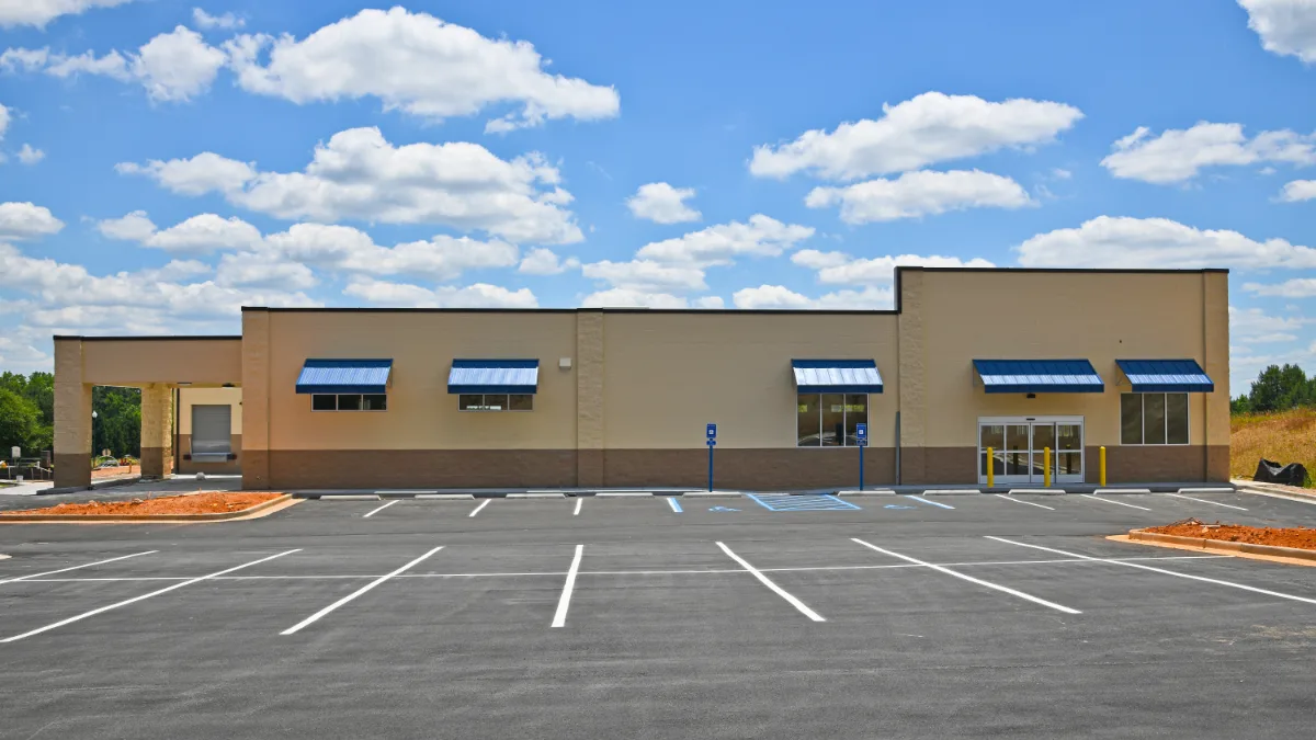 Freshly striped parking lot in front of a new commercial building